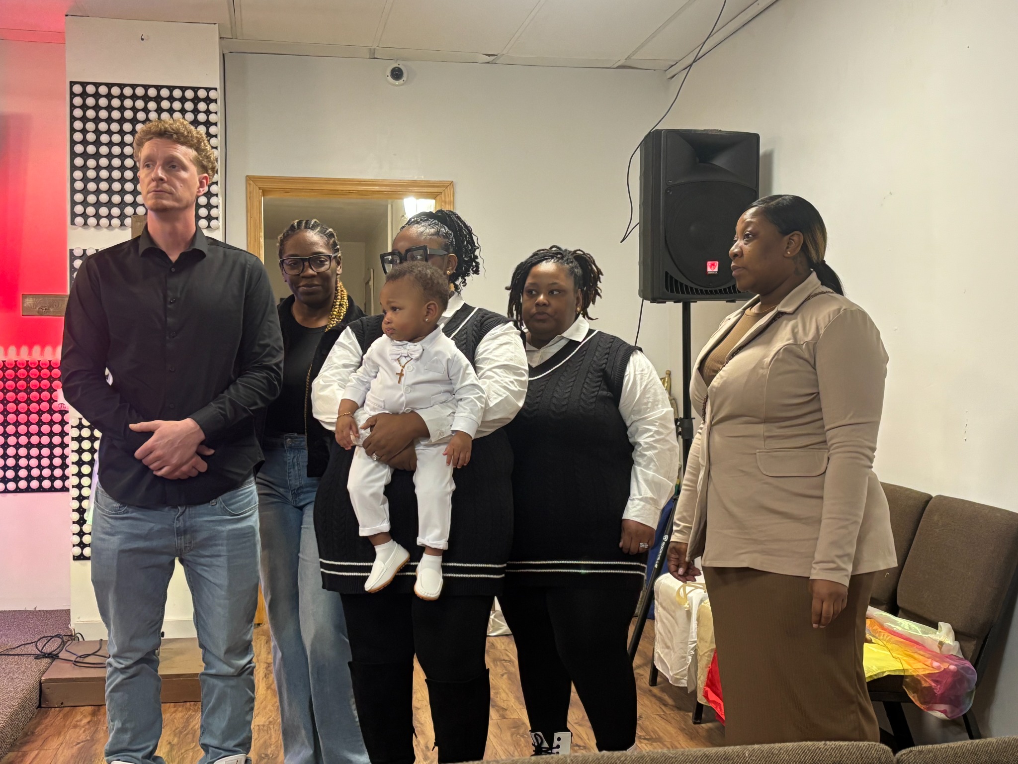 Family gathered with a child during a christening service