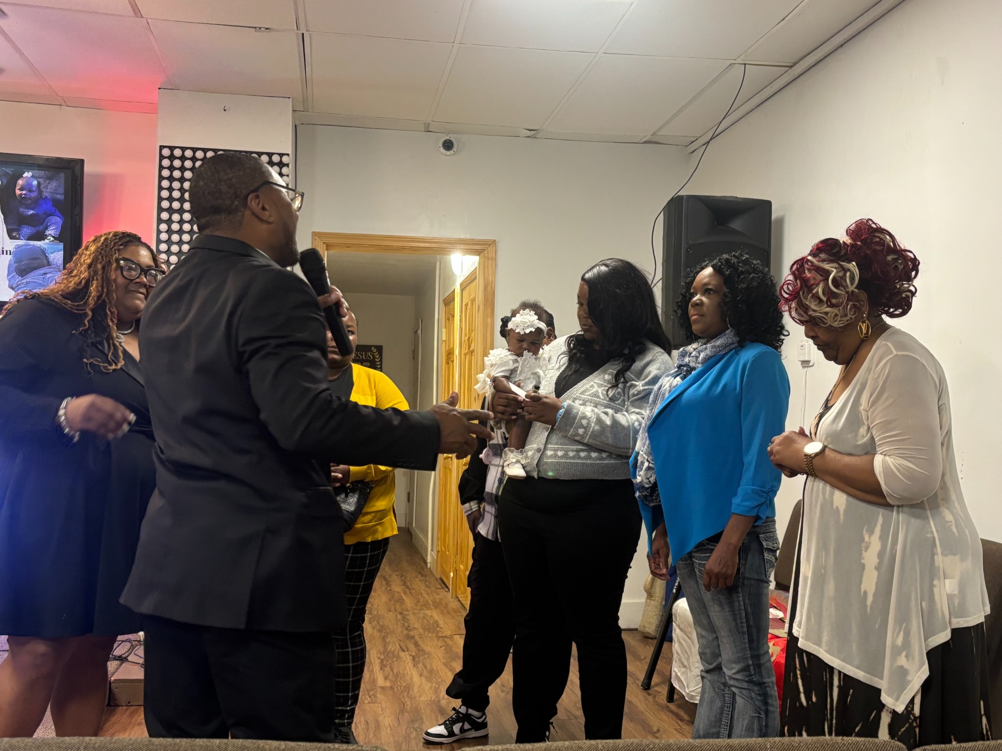 Pastor Ed Easley leading a family through a christening
