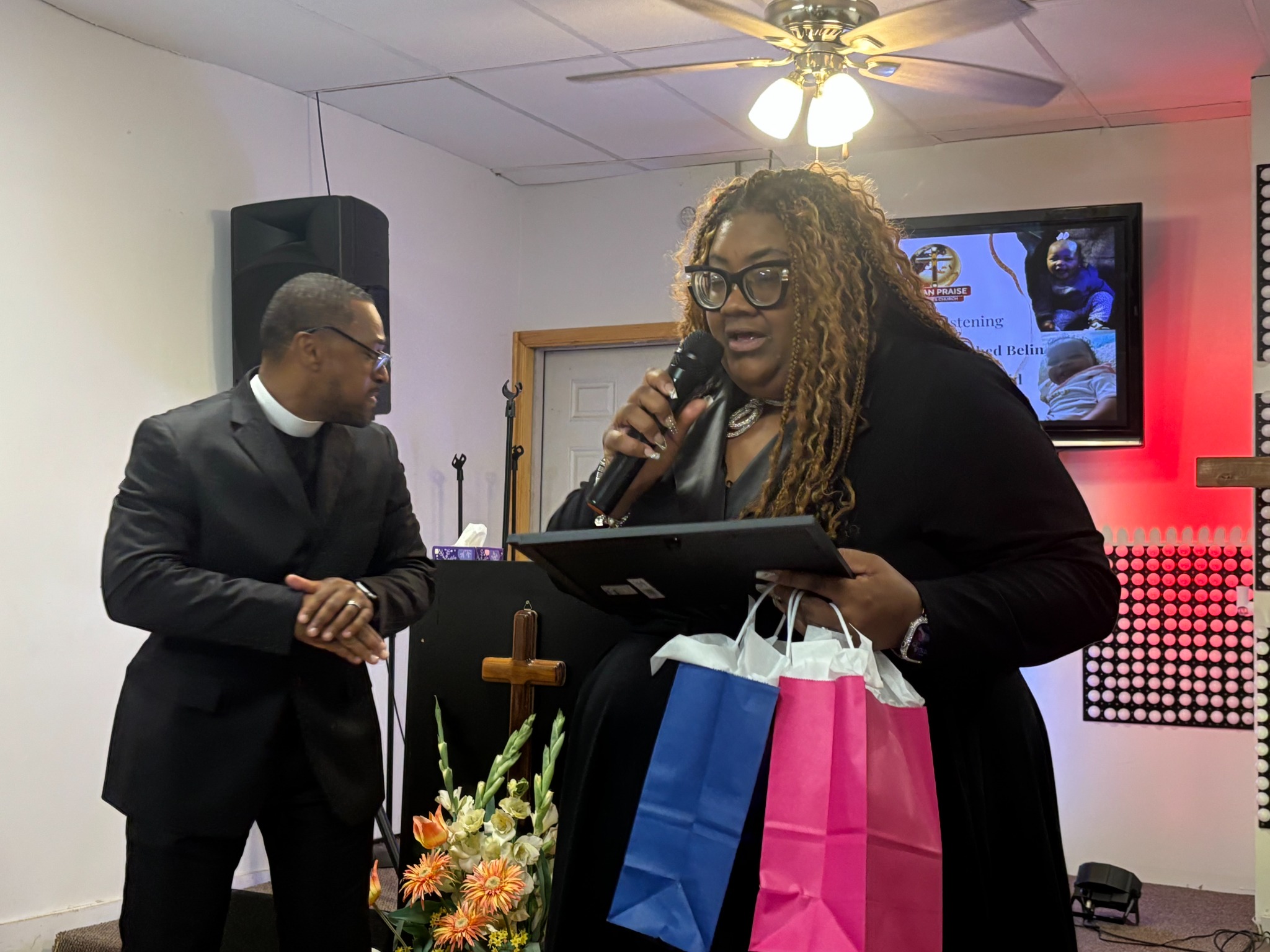 Dr. Cherise Easley presenting a christening keepsake