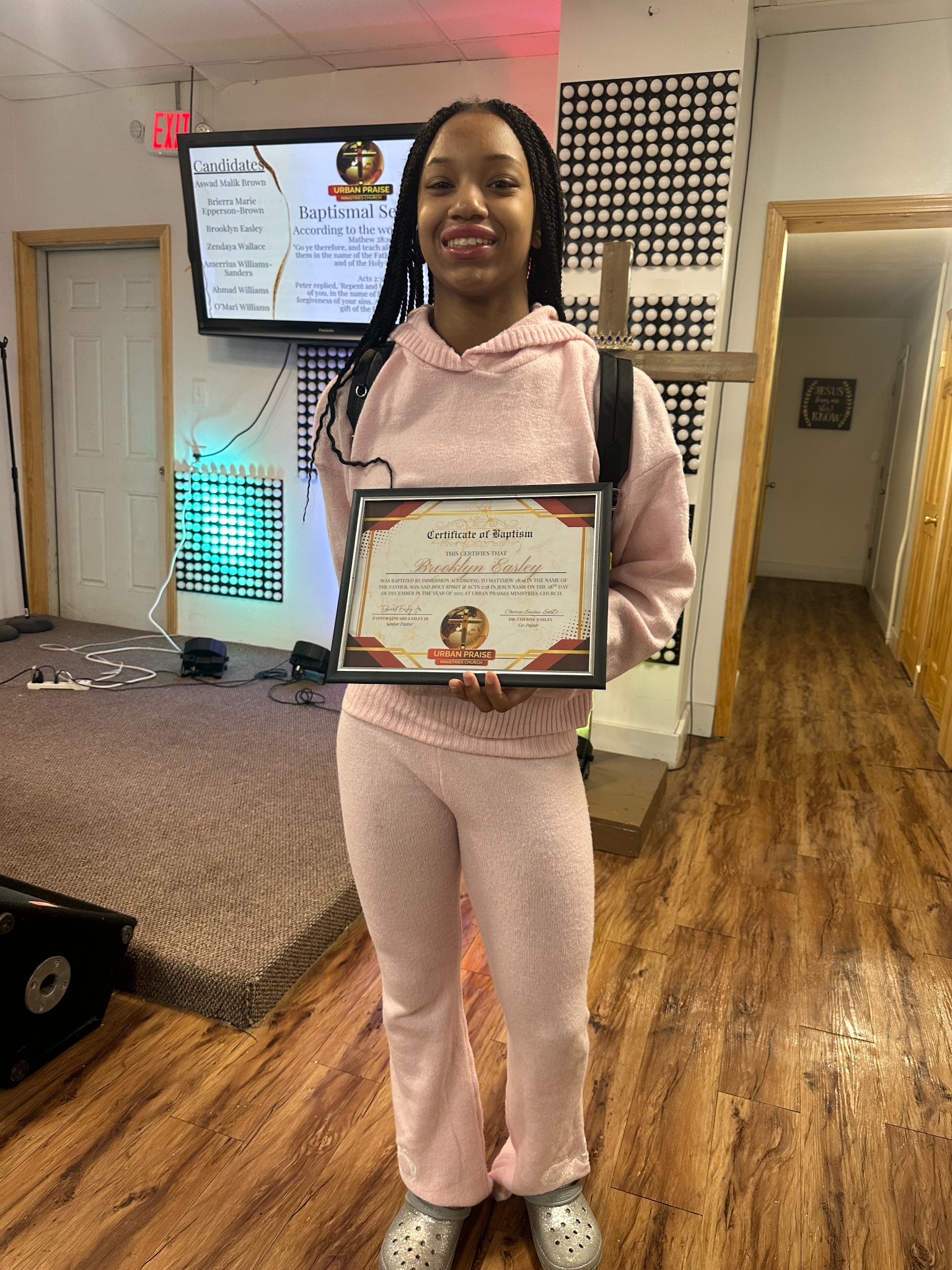 Young baptism candidate holding her certificate
