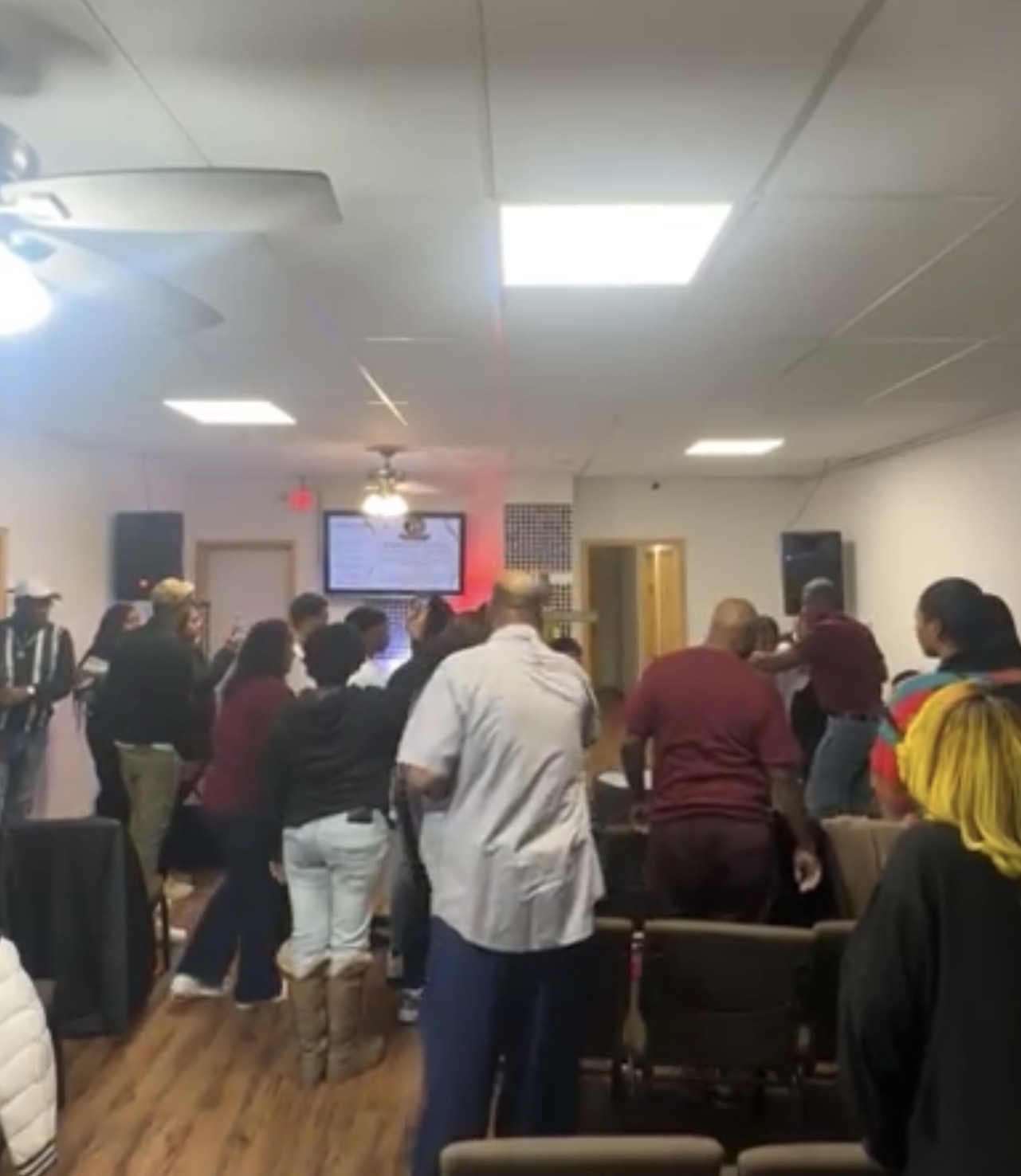 Congregation worshiping during the first baptismal service at the church