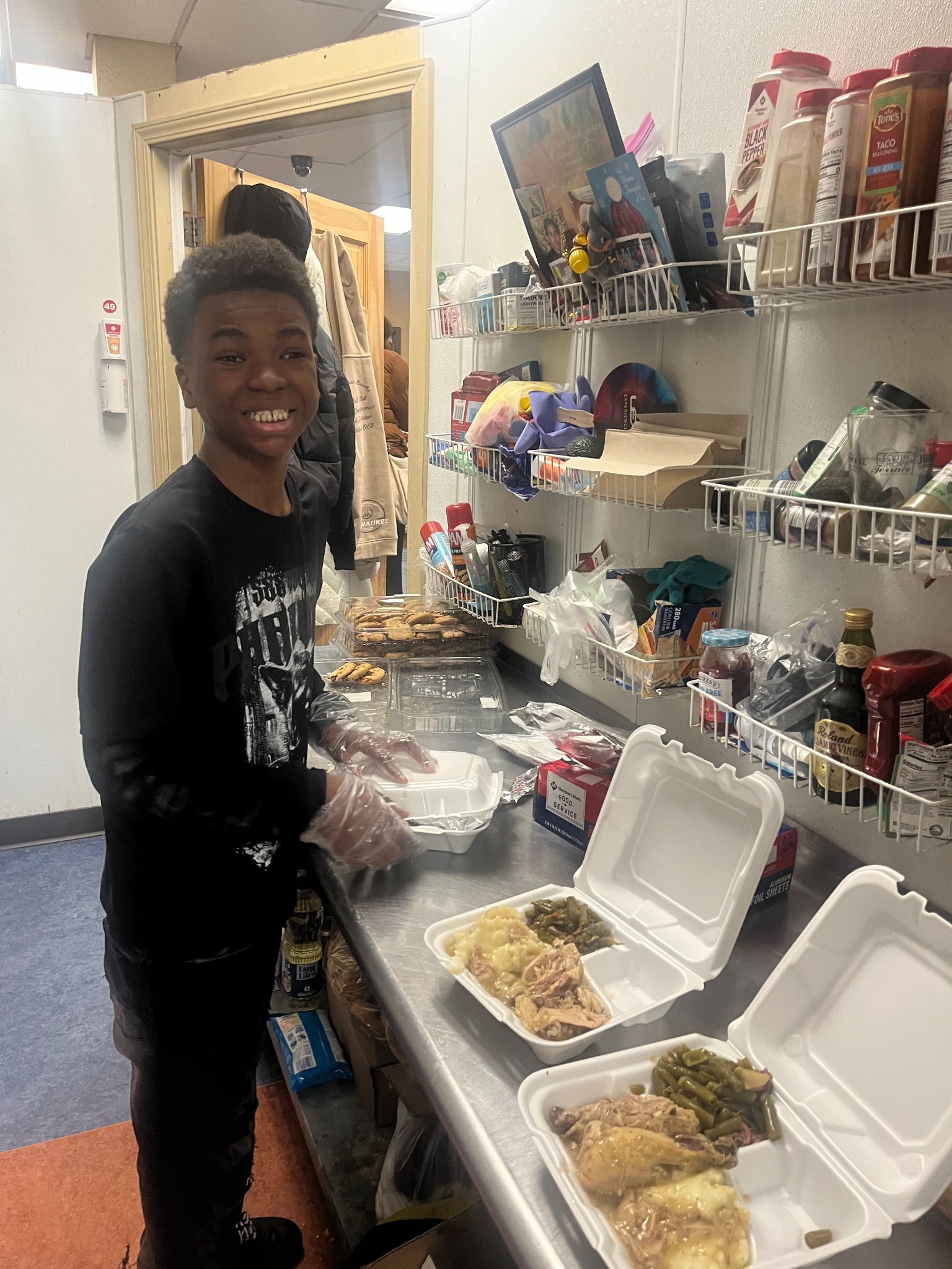 Young volunteer preparing meals at Repairers of the Breach