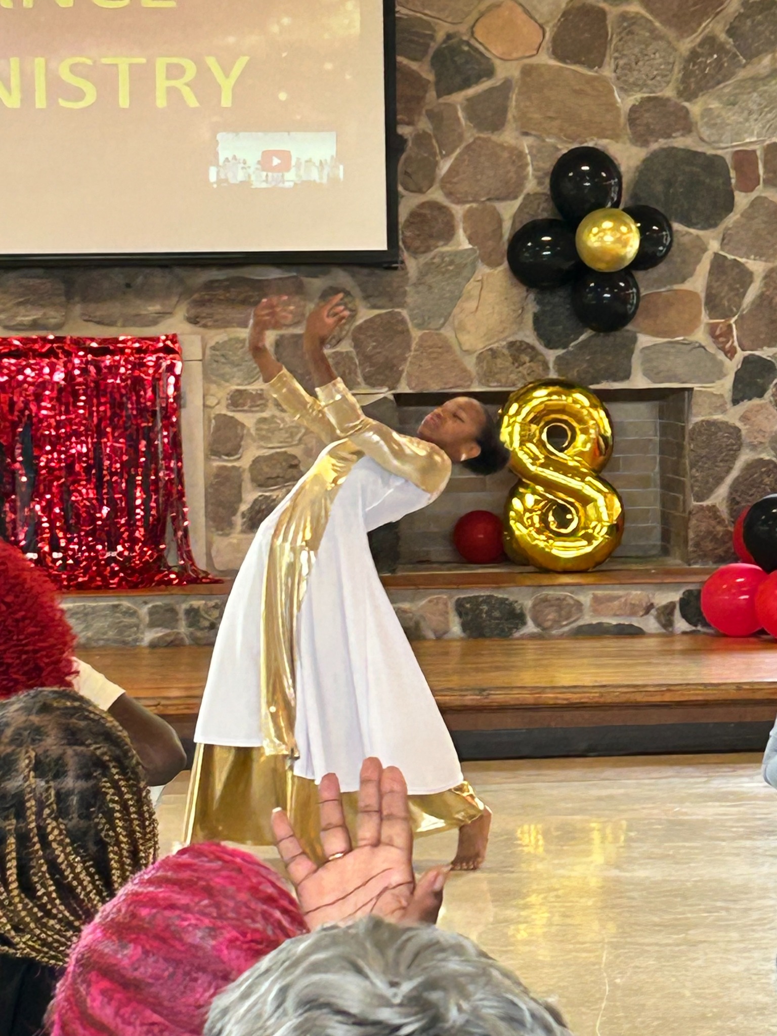 Praise dancer ministering in white and gold