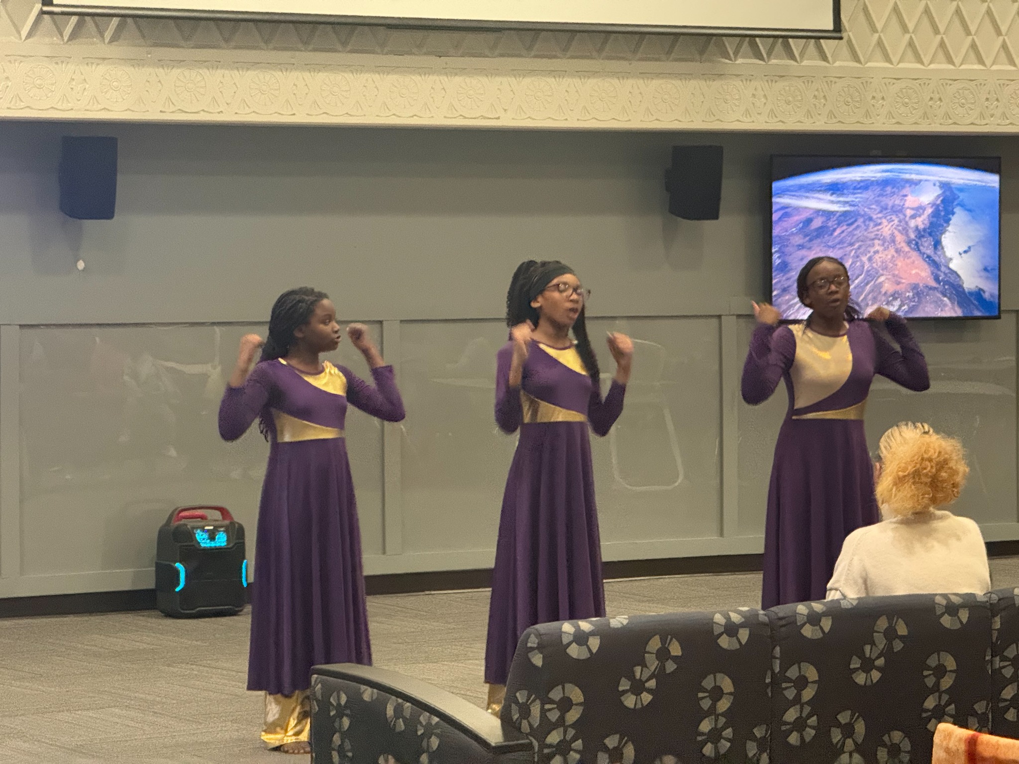 Praise dance team ministering in purple and gold